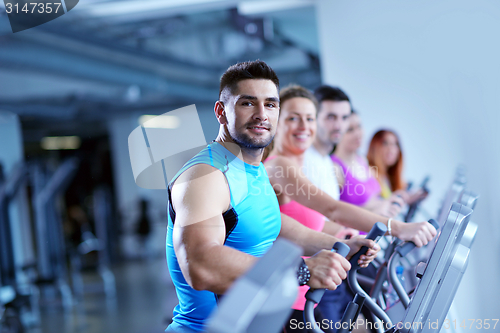 Image of Group of people running on treadmills