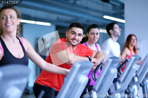 Image of Group of people running on treadmills