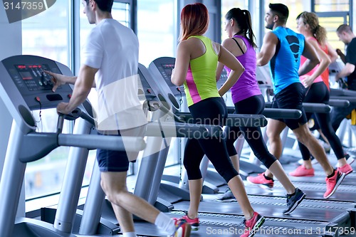 Image of Group of people running on treadmills