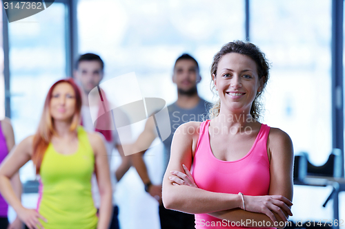 Image of Group of people exercising at the gym