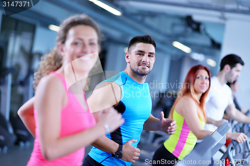 Image of Group of people running on treadmills