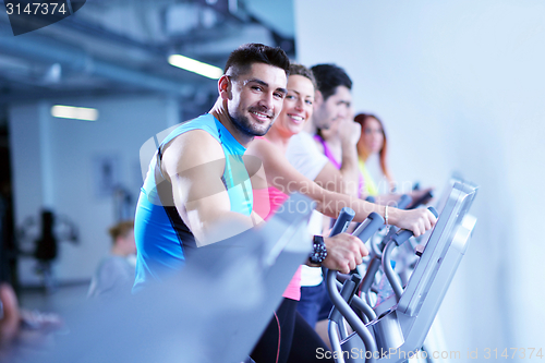 Image of Group of people running on treadmills