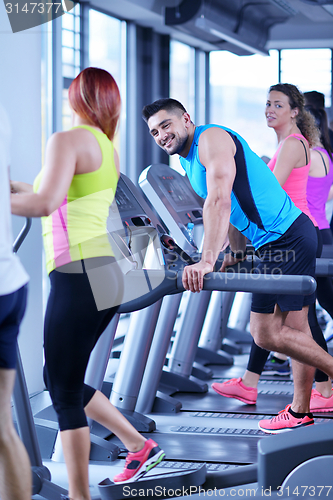 Image of Group of people running on treadmills