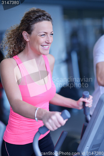 Image of woman exercising on treadmill in gym