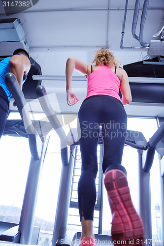 Image of woman exercising on treadmill in gym