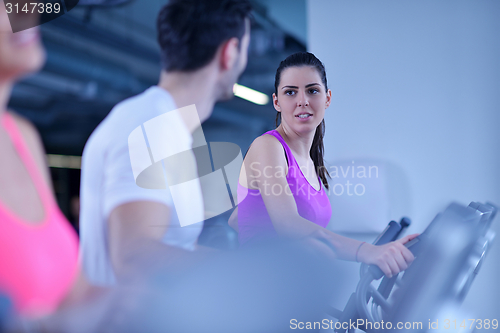 Image of Group of people running on treadmills