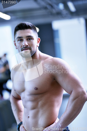 Image of handsome man exercising at the gym