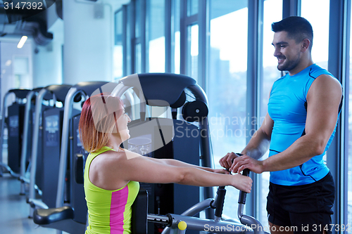 Image of woman exercising with her personal trainer