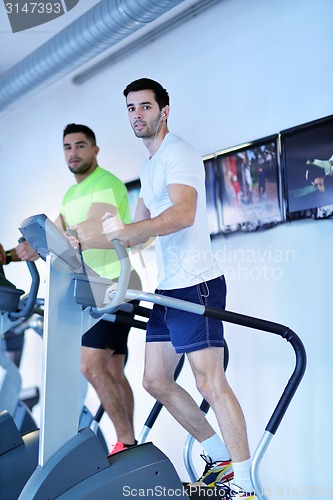 Image of Group of people running on treadmills