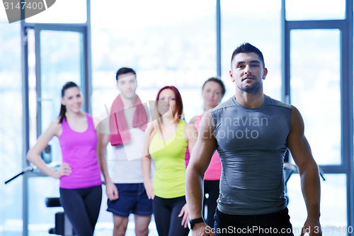 Image of Group of people exercising at the gym