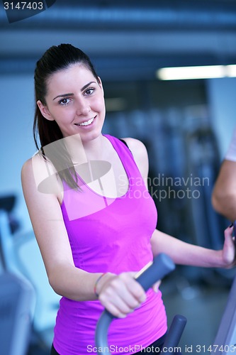 Image of woman exercising on treadmill in gym