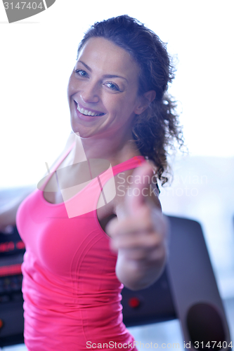 Image of woman exercising on treadmill in gym