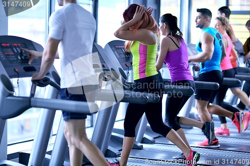 Image of Group of people running on treadmills