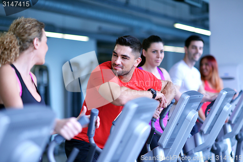 Image of Group of people running on treadmills