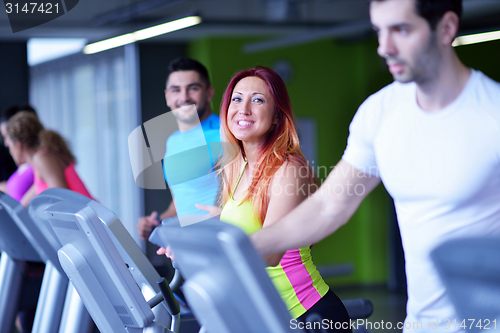 Image of Group of people running on treadmills