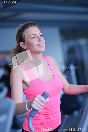 Image of woman exercising on treadmill in gym