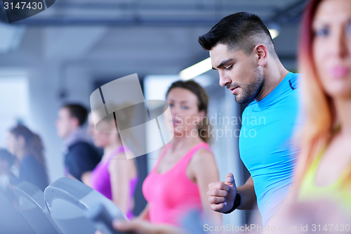 Image of Group of people running on treadmills