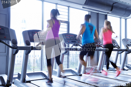 Image of Group of people running on treadmills