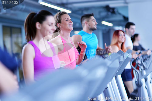 Image of Group of people running on treadmills