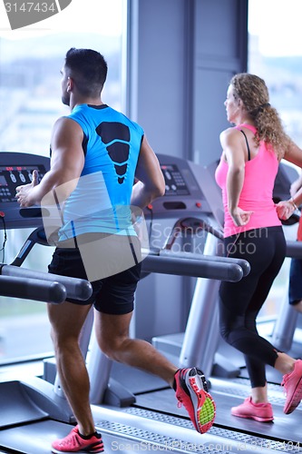 Image of Group of people running on treadmills