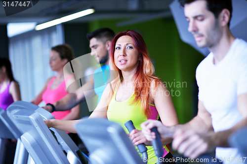 Image of Group of people running on treadmills