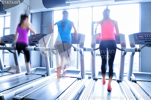 Image of Group of people running on treadmills