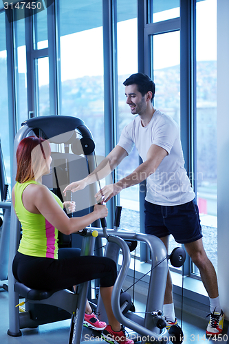 Image of woman exercising with her personal trainer