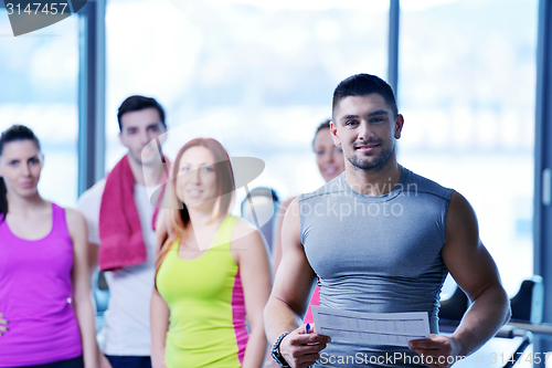 Image of Group of people exercising at the gym