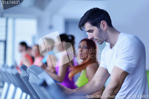 Image of Group of people running on treadmills