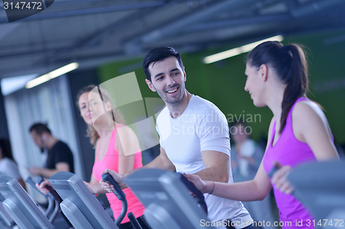 Image of Group of people running on treadmills