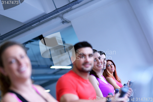 Image of Group of people running on treadmills