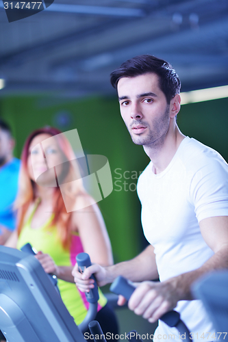 Image of Group of people running on treadmills