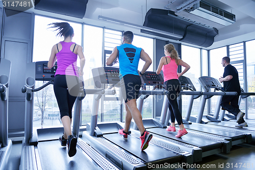 Image of Group of people running on treadmills