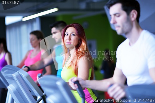 Image of Group of people running on treadmills