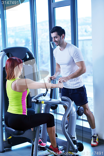 Image of woman exercising with her personal trainer