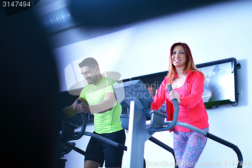 Image of Group of people running on treadmills