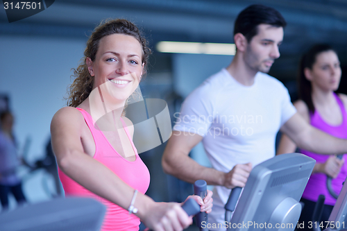 Image of Group of people running on treadmills