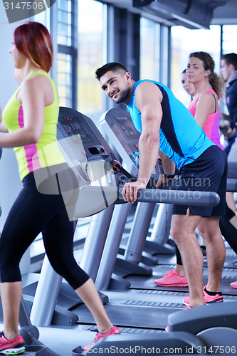 Image of Group of people running on treadmills