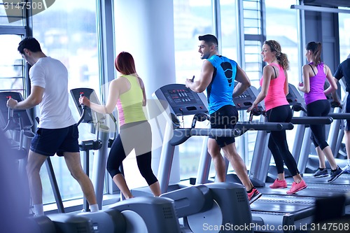 Image of Group of people running on treadmills