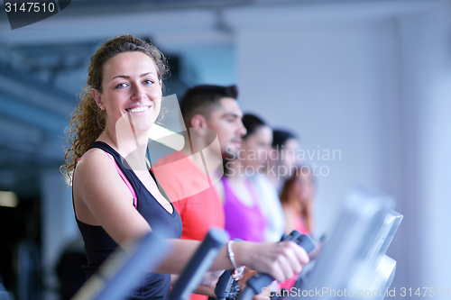 Image of Group of people running on treadmills