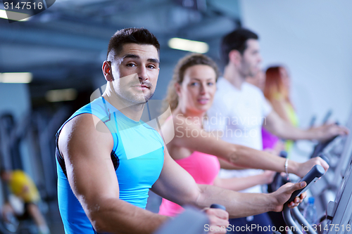 Image of Group of people running on treadmills