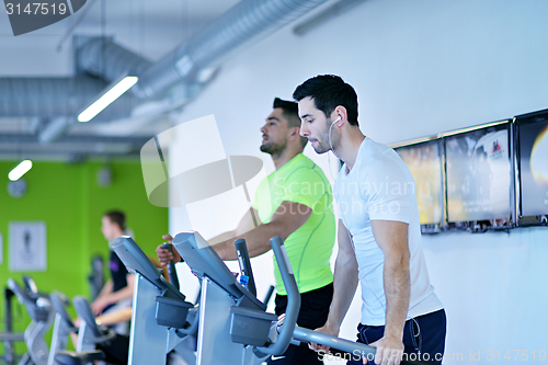 Image of Group of people running on treadmills