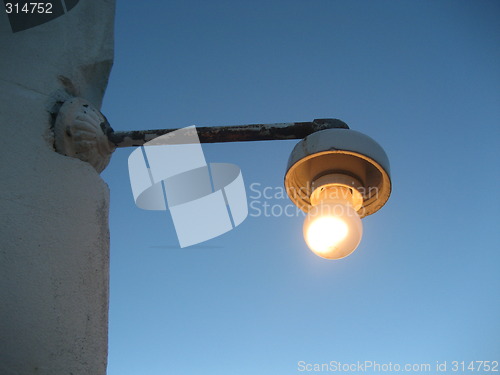 Image of Old lamp on wall in early evening