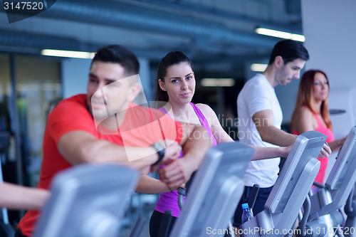 Image of Group of people running on treadmills