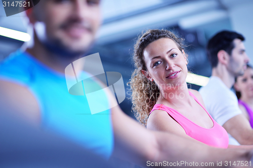 Image of Group of people running on treadmills