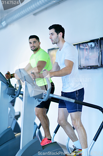 Image of Group of people running on treadmills