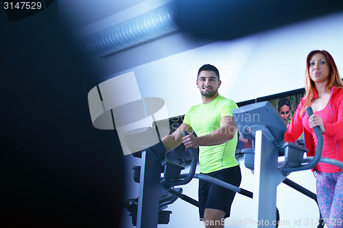 Image of Group of people running on treadmills