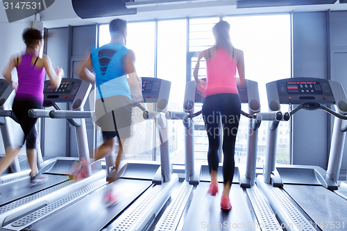 Image of Group of people running on treadmills