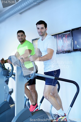 Image of Group of people running on treadmills