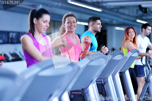 Image of Group of people running on treadmills